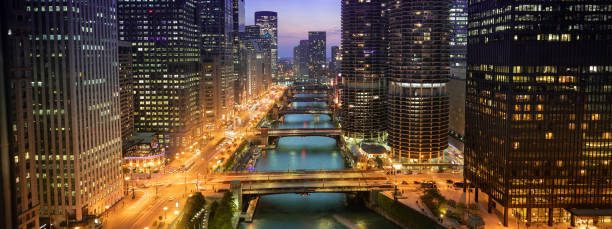 Chicago cityscape panorama and bridges over the river at night Downtown city buildings and panoramic skyline over the Chicago River at night in Illinois USA michigan avenue chicago stock pictures, royalty-free photos & images