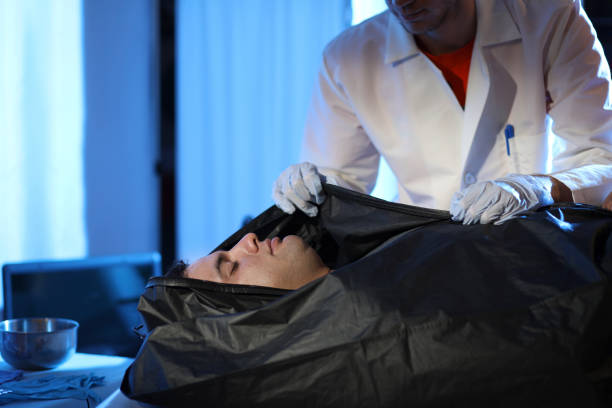 istock Medical Examiner with corpse in morgue. 1149570365