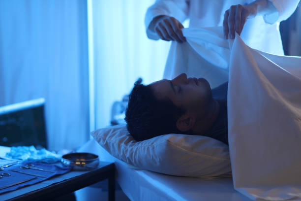 istock Medical Examiner with corpse in morgue. 1149571324