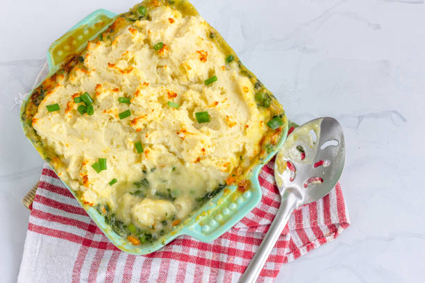 Fish Pie on Table Classic Fish Pie with Mashed Potato in a Baking Tray, Directly Above Photo fish pie stock pictures, royalty-free photos & images