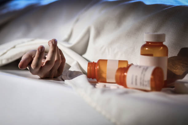 Corpse in morgue demonstrates death by drug overdose. Covered corpse in morgue. Man dies from prescription drug overdose. Opioid addiction themes. self mutilation pictures stock pictures, royalty-free photos & images