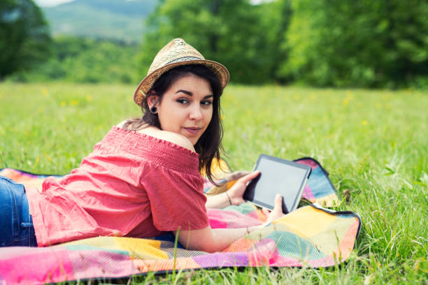 istock Woman using tablet outdoor. 1149571853