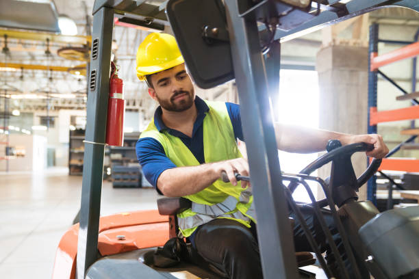 istock Bearded young man driving forklift in factory 1149576032