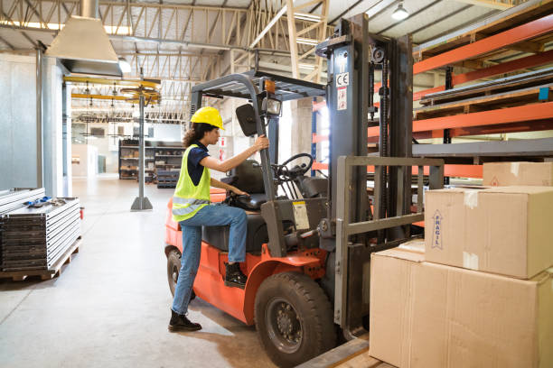 istock Full length of female driver boarding forklift 1149576747