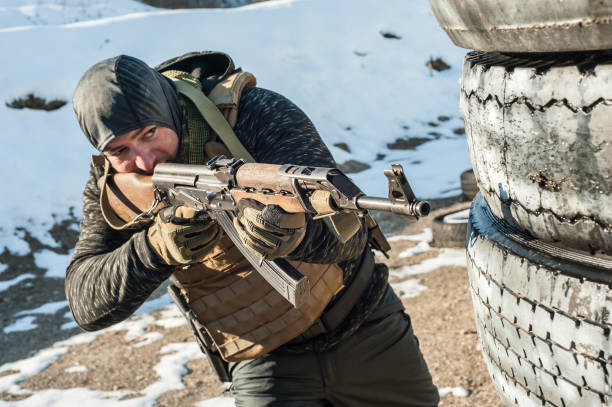 istock Special forces soldier in action, shooting from rifle machine gun 1149577348