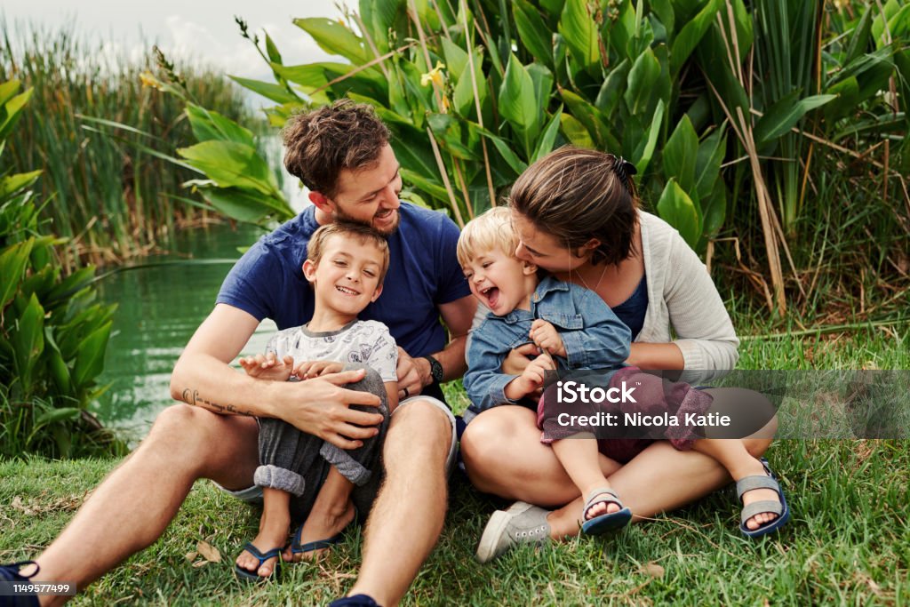 We're answering to natures call today Full length shot of a beautiful young family of four spending some time together outdoors Father Stock Photo