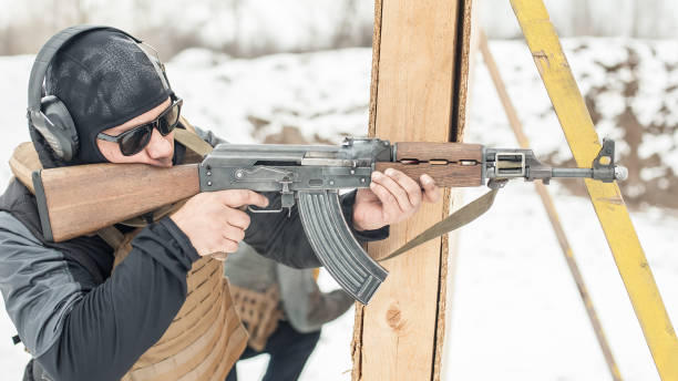 istock Special forces soldier in action, shooting from rifle machine gun 1149578639