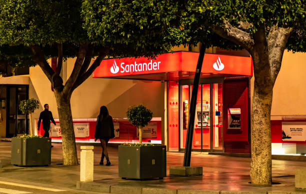 Night view of Santander bank office in Almeria, Spain. stock photo