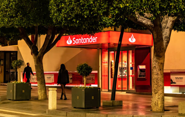 night view of santander bank office in almeria, spain. - santander imagens e fotografias de stock