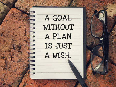 A Goal Without A Plan Is Just A Wish written on a notebook.