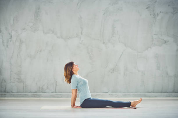 istock Woman doing yoga on mat. 1149582558