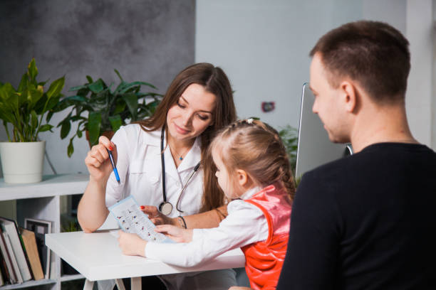 istock Young professional pediatrician shows prescriptions to a child. 1149585475