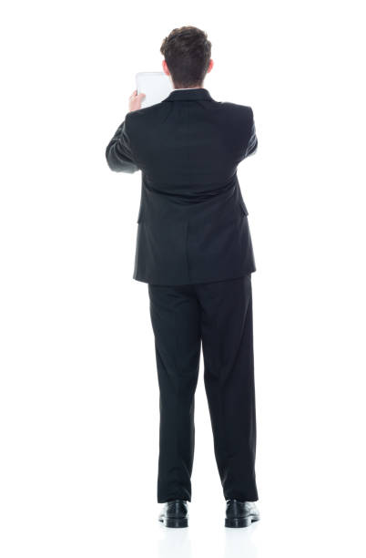 istock Young handsome businessman wearing a suit and tie - using tablet 1149585849