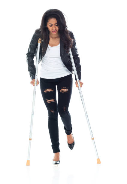 istock Bautiful woman wearing a leather jacket and using crutches 1149586817
