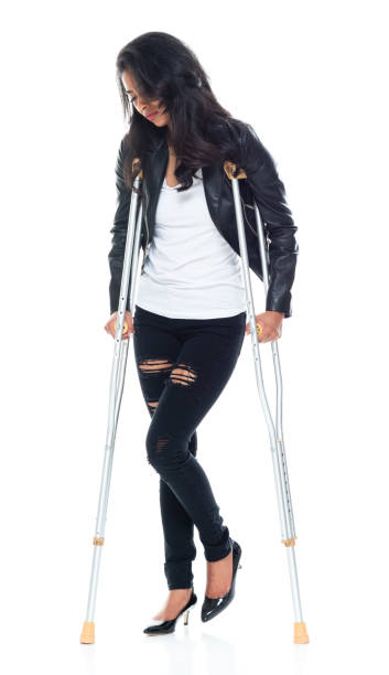 istock Bautiful woman wearing a leather jacket and using crutches 1149587057