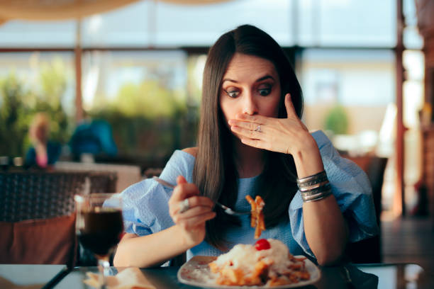 istock Woman Feeling Sick While Eating Huge Meal 1149589092