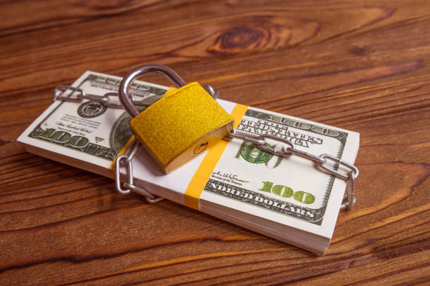 istock a pack of American dollars tied with an iron chain 1149590889