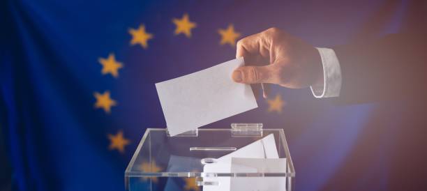 istock Man throwing his vote into the ballot box. 1149591102