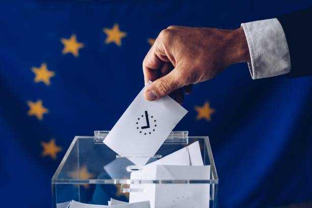 istock Man throwing his vote into the ballot box. 1149591139