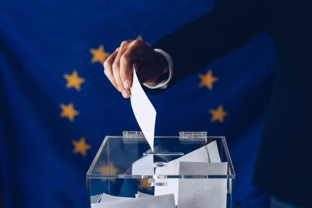 Man throwing his vote into the ballot box.