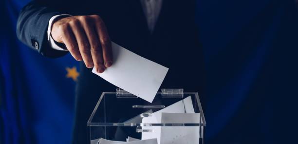 istock EU elections. Man throwing his vote into the ballot box. 1149591768