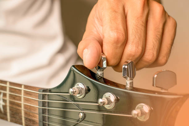 the musician tuning his guitar