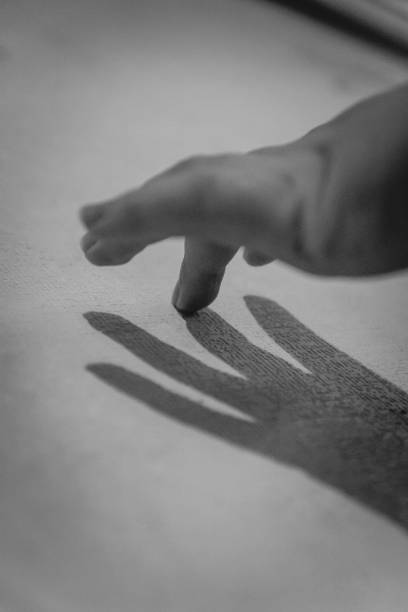 istock Hand and her shadow on the wall. Black and white. Monochrome 1149595067