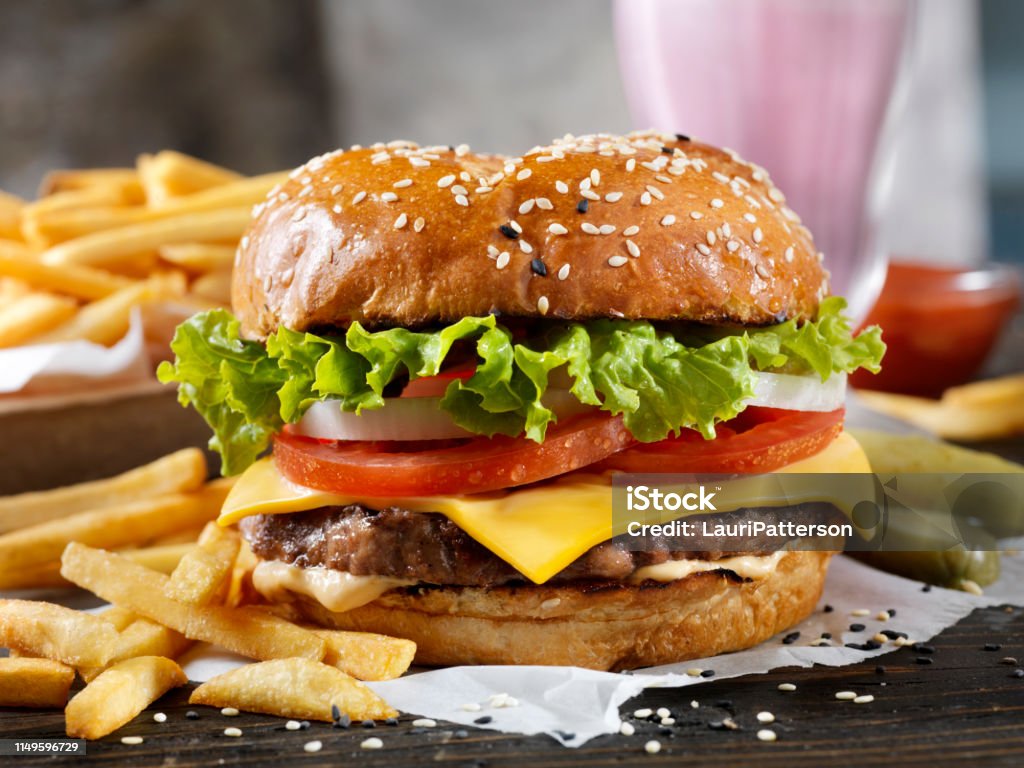 Classic Cheeseburger on a Brioche Bun with Fries and a Milkshake Burger Stock Photo