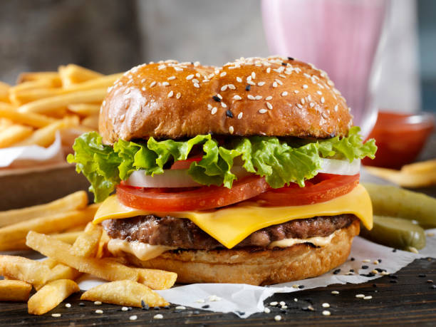 Classic Cheeseburger on a Brioche Bun with Fries and a Milkshake Classic Cheeseburger on a Brioche Bun with Fries and a Milkshake cheeseburger stock pictures, royalty-free photos & images