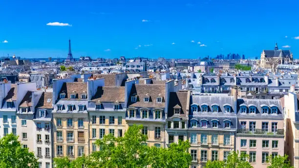 Paris, typical roofs in the Marais, aerial view with the Eiffel Tower, the Saint-Eustache church and the Defense in background