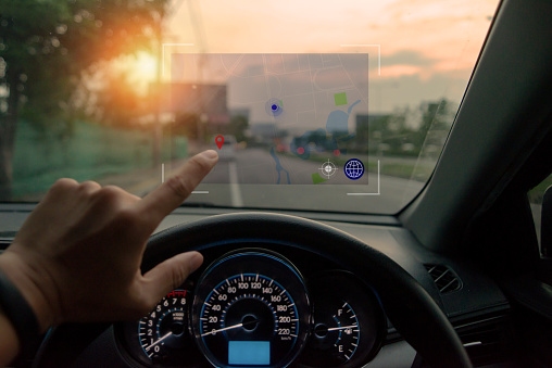 Technology in the near future,Pushing on a touch screen interface navigation system in interior of modern car.