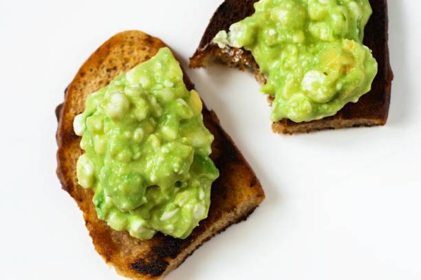 istock Avocado spread on toast, one is biten. 1149600977
