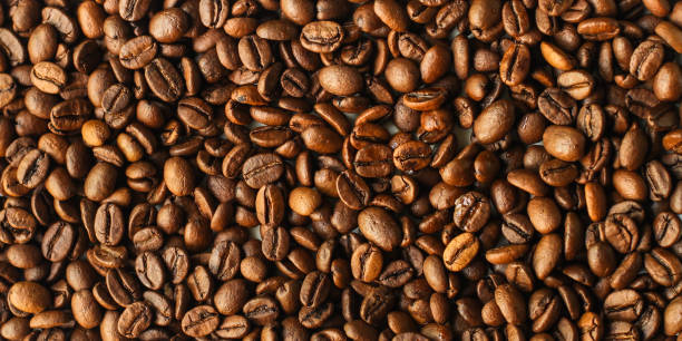 istock coffee beans (good and bad grain) - arabica and robusta blend (roasted coffee grain). Black background. Top view . Copy space 1149602220