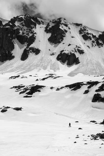 istock Black and white high mountain with snow cornice and avalanche trail 1149604668