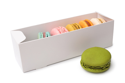 Colorful french macaroons in gift box on white background