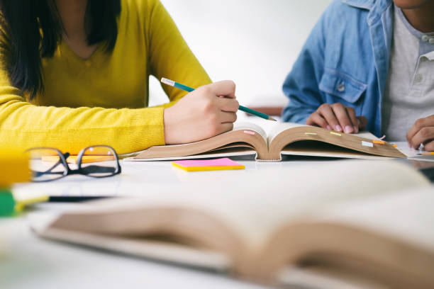 istock Young students campus helps friend catching up and learning. 1149608165