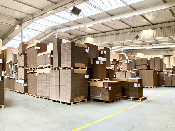 гофрированные картонные поддоны на общем складе - corrugated cardboard box cardboard industry стоковые фото и изображения