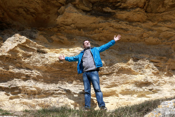 istock Man posing on background of cave 1149609874