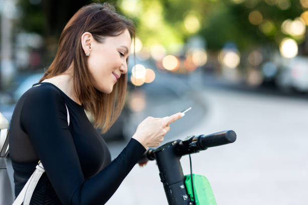 istock A woman using a mobile phone for unlocking an electric scooter by app 1149611399