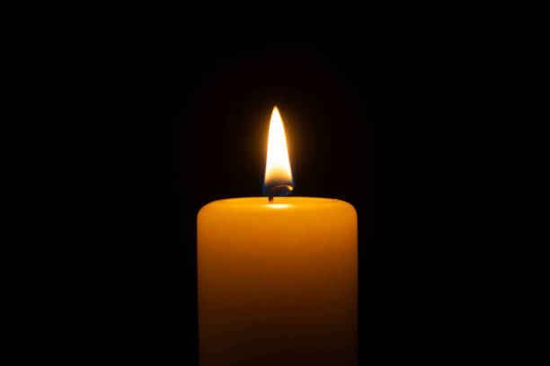 istock Close up of orange wax candle flame 1149611601