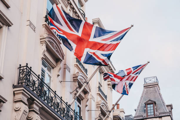 Union Jack British flag on a pole outside a building in London, UK. stock photo