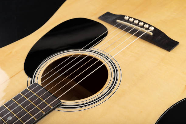 istock Classical guitar on a dark wooden table. Musical instrument stringed. Black background. 1149611650