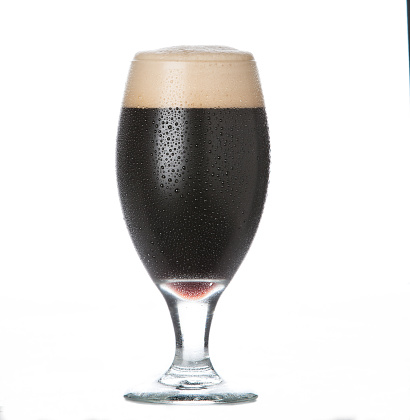 Stout beer in pint glass on white background