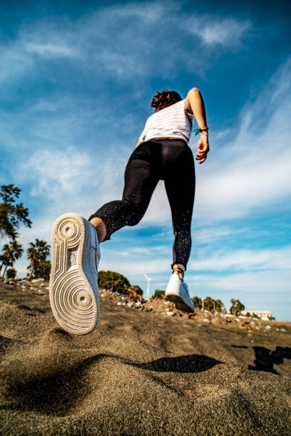 istock young woman jogging in the park 1149613329