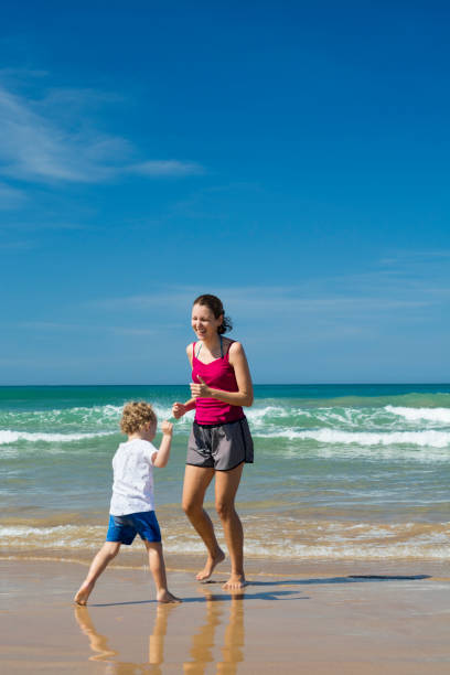 istock Young woman with her son enjoying the beach 1149613502