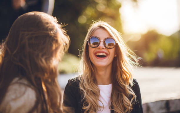 istock Two smiling girls in a public park 1149619255