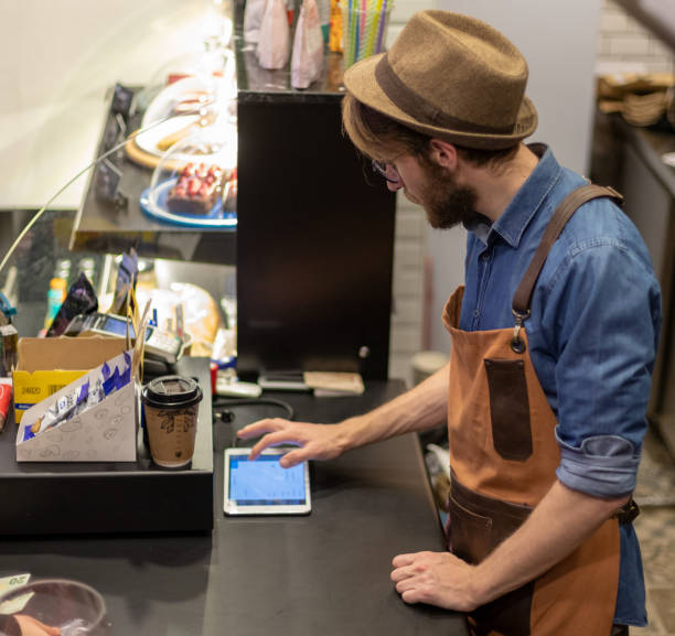 istock barista reading message on phone 1149619547