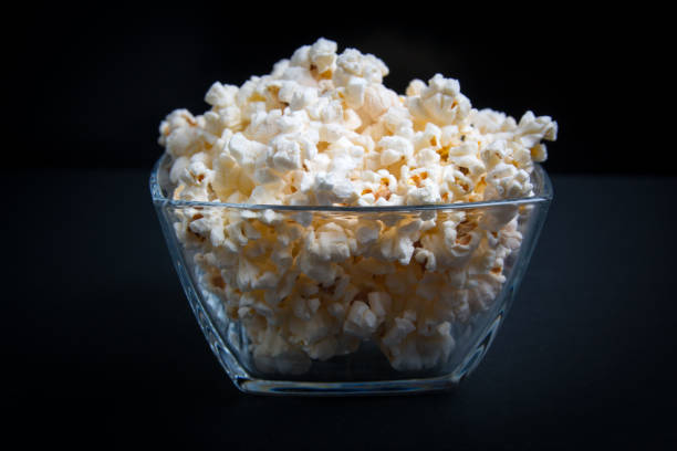 istock popcorn in a glass bowl on a black background 1149620843