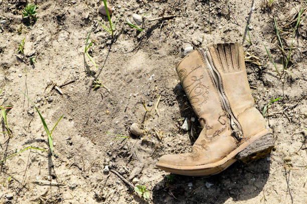 istock small dirty western cowboy boot on dry ground 1149622505