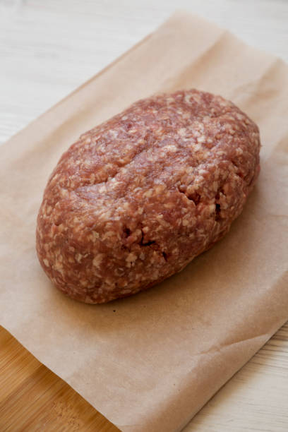 istock Fresh raw grass fed ground beef on a bamboo board, side view. Close-up. 1149622577